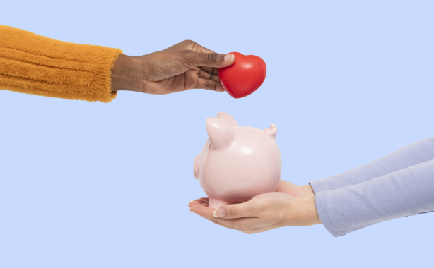 a dark skinned hand is holding her arm out with a red heart in her hand. There is another person with their hands cupped holding a piggy bank out below the heart
