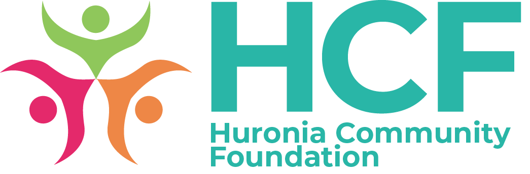 HCF Huronia Community Foundation written in turquoise with a stylized logo of 3 people in green, orange and red to the left