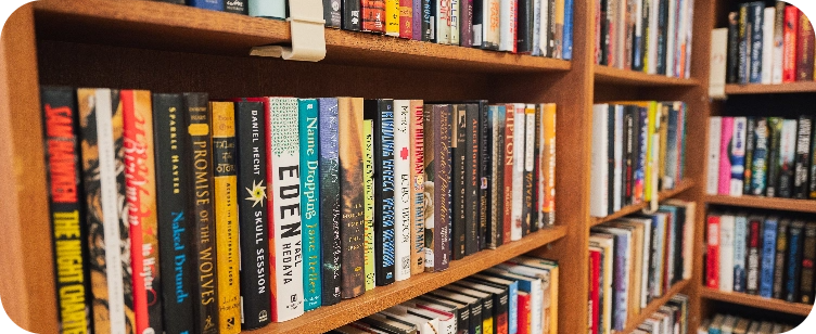 wooden bookshelf's stacked with books